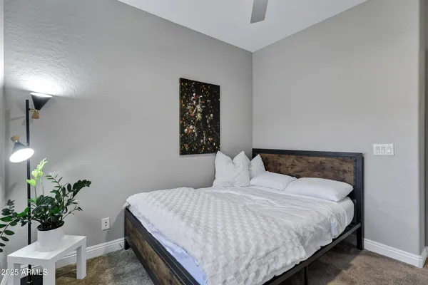 a bedroom with a bed and a potted plant