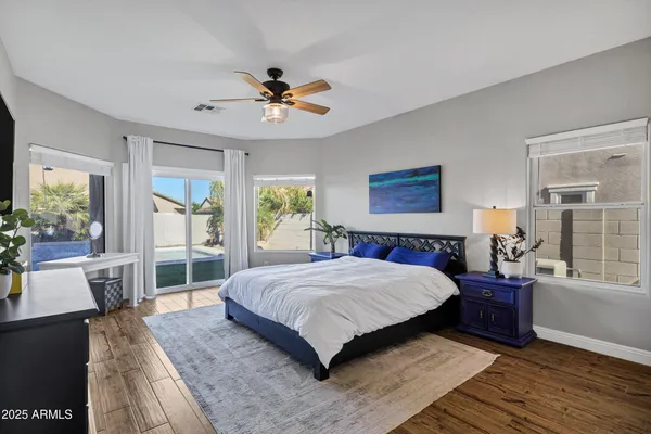 a bedroom with a large bed and a chandelier
