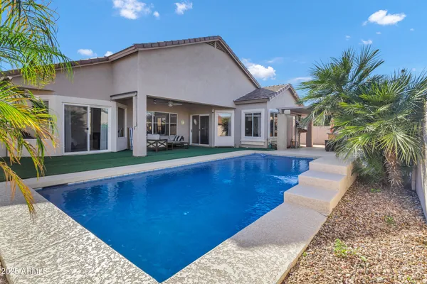 a view of a house with a backyard and a patio