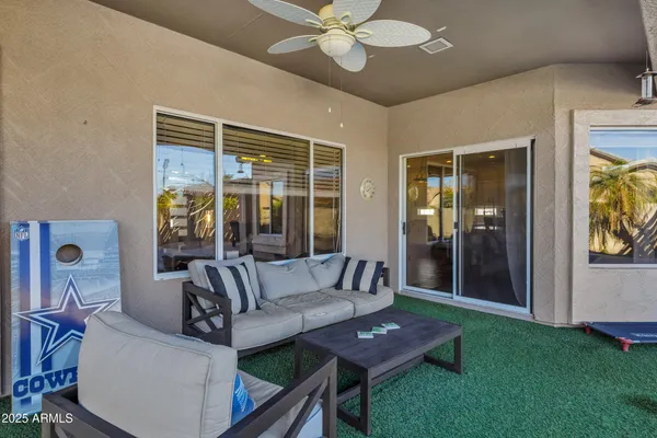 a view of a porch with furniture and a yard