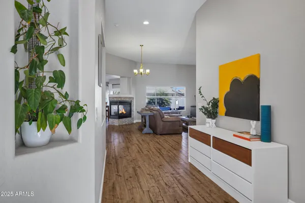 a very nice looking room with wooden floor and a large mirror