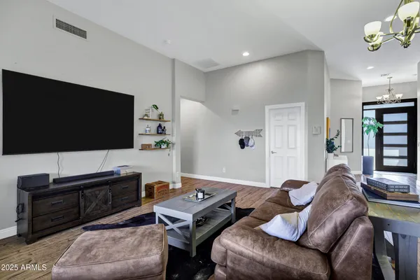 a living room with furniture a fireplace and a flat screen tv