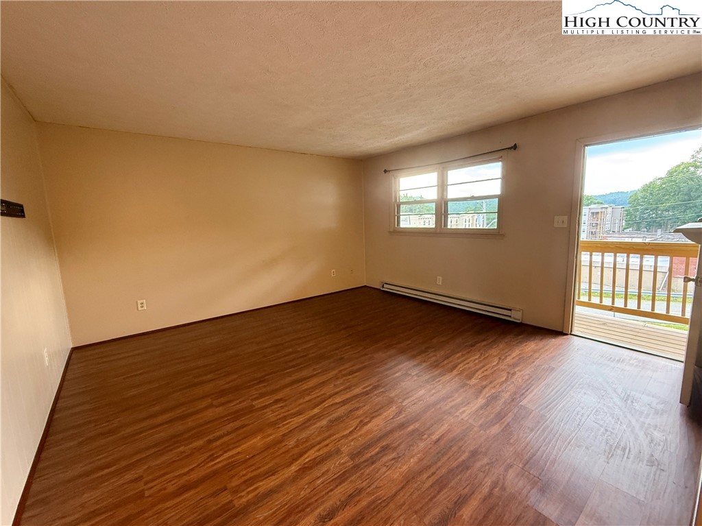 134 Mac Street, Unit 10 Boone, NC 28607 - Photo 12 of 15 a view of a room with wooden floor and windows