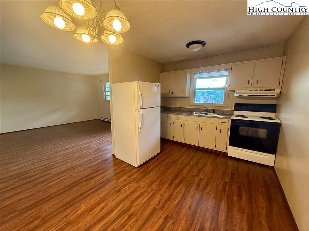 134 Mac Street, Unit 10 Boone, NC 28607 - Photo 14 of 15 a kitchen with a sink wooden floor and stainless steel appliances