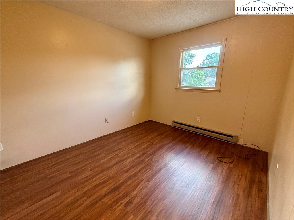 134 Mac Street, Unit 10 Boone, NC 28607 - Photo 8 of 15 a view of empty room with wooden floor and fan