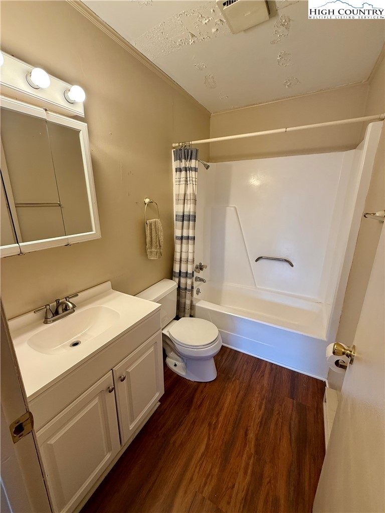 134 Mac Street, Unit 10 Boone, NC 28607 - Photo 9 of 15 a bathroom with a sink mirror vanity and toilet
