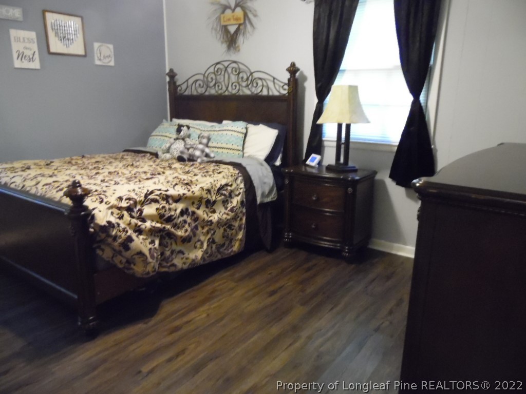 6799 Faircloth Bridge Road Stedman, NC 28391 - Photo 13 of 25 a bed sitting in a bedroom next to a window