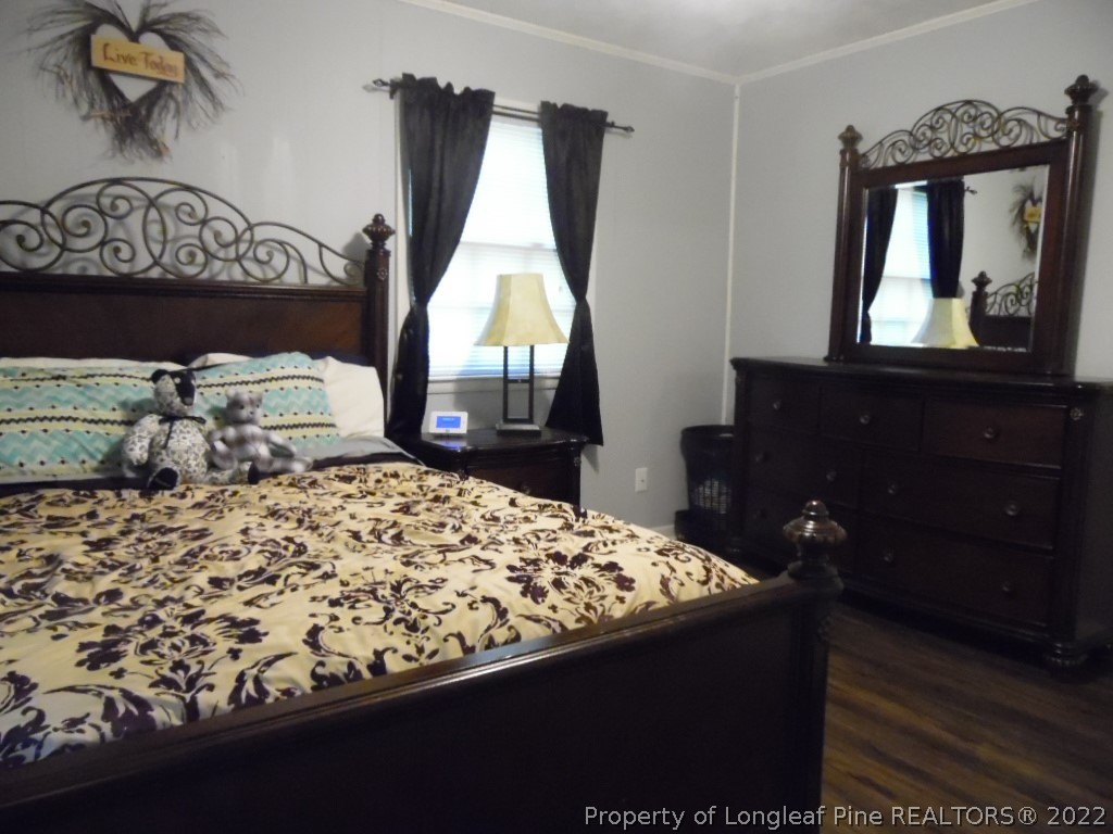 6799 Faircloth Bridge Road Stedman, NC 28391 - Photo 14 of 25 a bedroom with a bed window and dresser