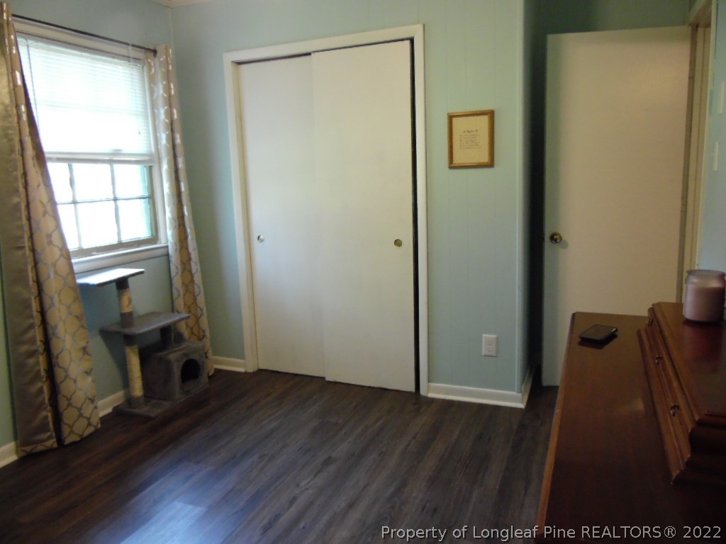 6799 Faircloth Bridge Road Stedman, NC 28391 - Photo 17 of 25 a view of an empty room with wooden floor and a window