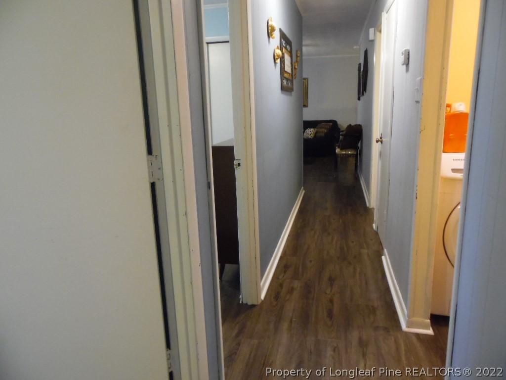 6799 Faircloth Bridge Road Stedman, NC 28391 - Photo 19 of 25 a view of a hallway with wooden floor and staircase