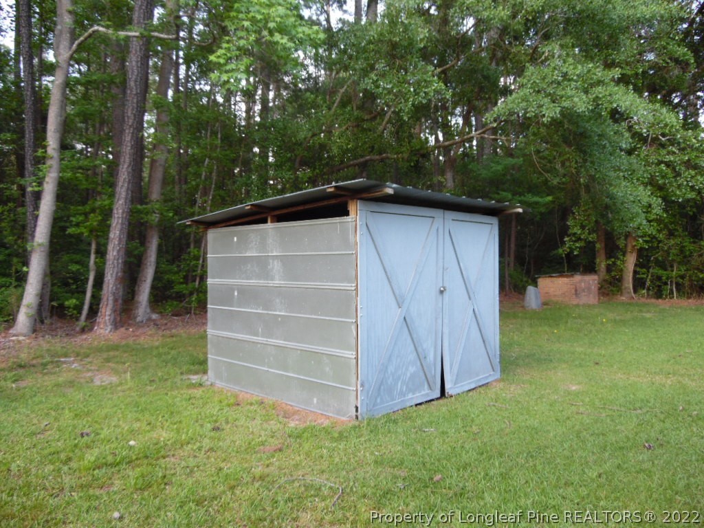 6799 Faircloth Bridge Road Stedman, NC 28391 - Photo 23 of 25 a view of backyard with potted plants and large tree