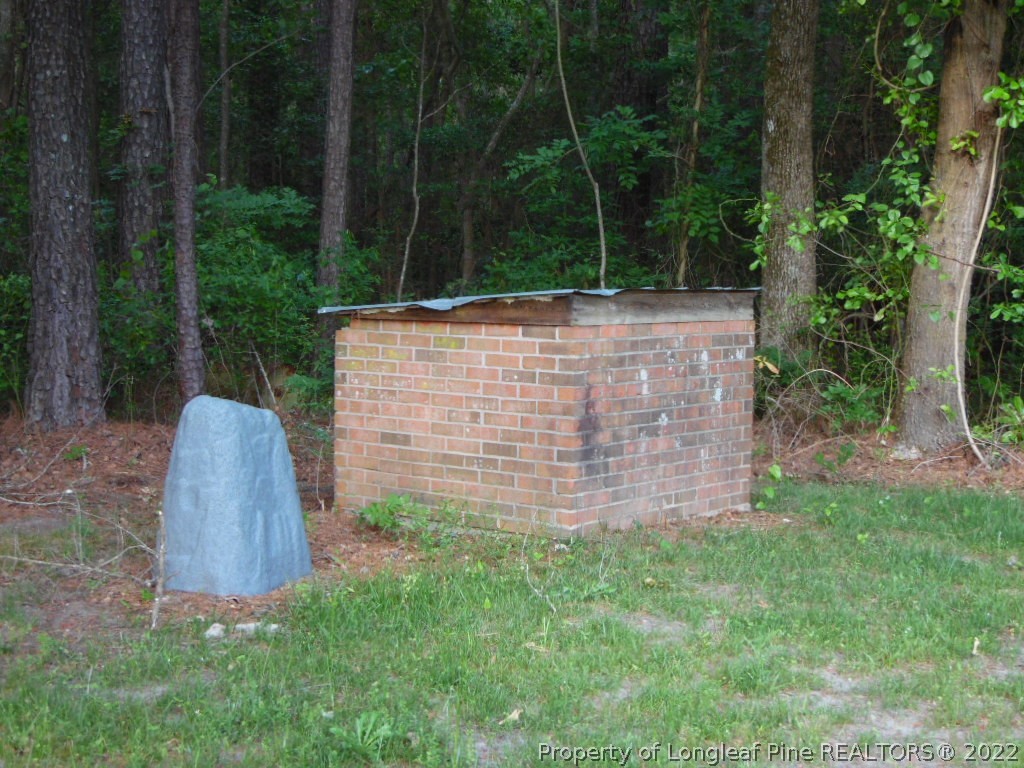 6799 Faircloth Bridge Road Stedman, NC 28391 - Photo 24 of 25 a view of a garden with large trees