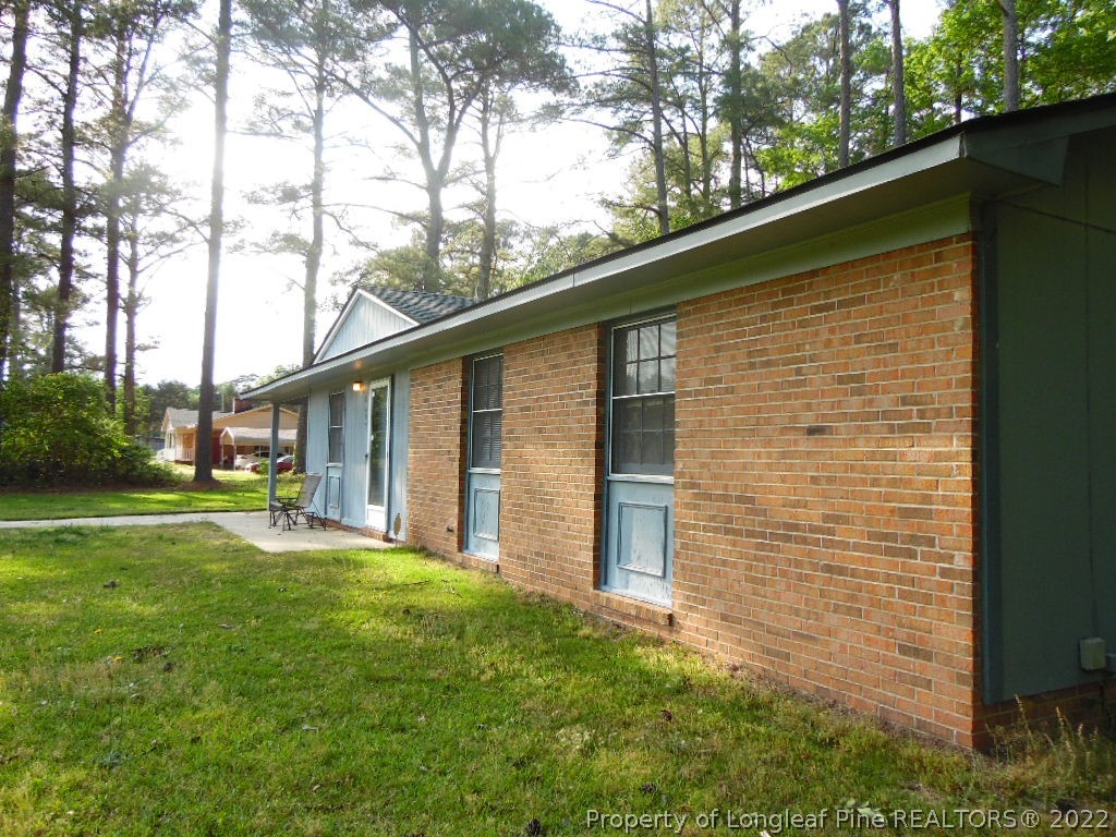 6799 Faircloth Bridge Road Stedman, NC 28391 - Photo 3 of 25 a backyard of a house with table and chairs