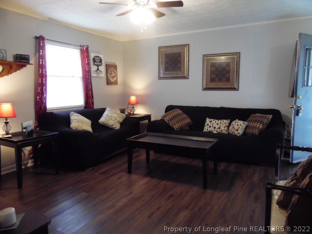6799 Faircloth Bridge Road Stedman, NC 28391 - Photo 4 of 25 a living room with furniture a window and wooden floor
