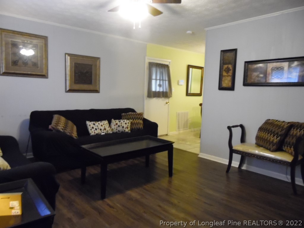 6799 Faircloth Bridge Road Stedman, NC 28391 - Photo 5 of 25 a living room with furniture and a wooden floor