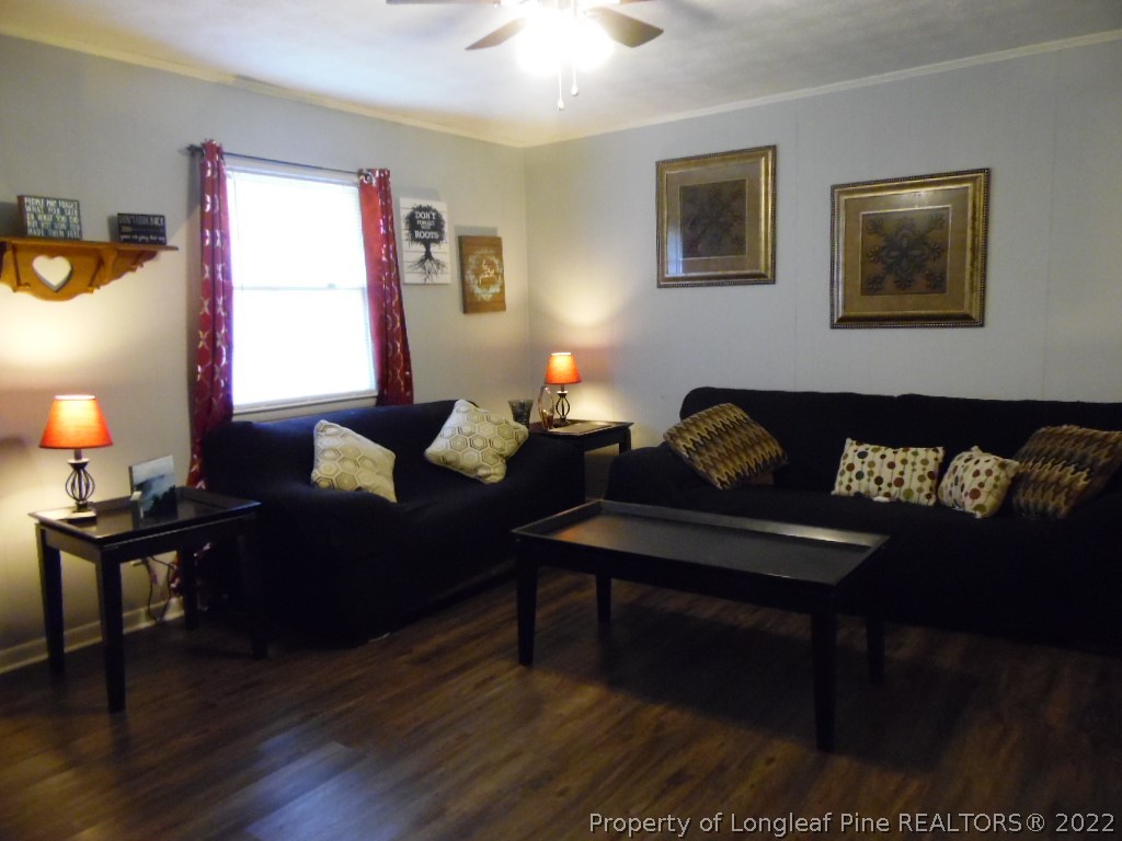 6799 Faircloth Bridge Road Stedman, NC 28391 - Photo 7 of 25 a living room with furniture and a lamp