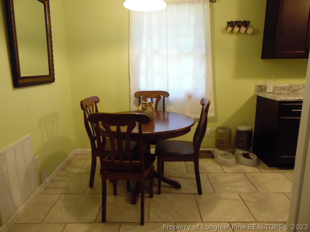 6799 Faircloth Bridge Road Stedman, NC 28391 - Photo 10 of 25 a dining room with furniture and window