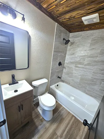 a bathroom with a sink a toilet a mirror and bathtub