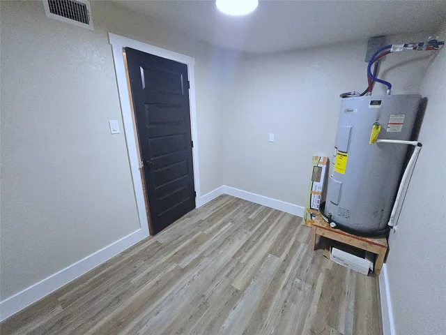 a view of a room with wooden floor and bathroom