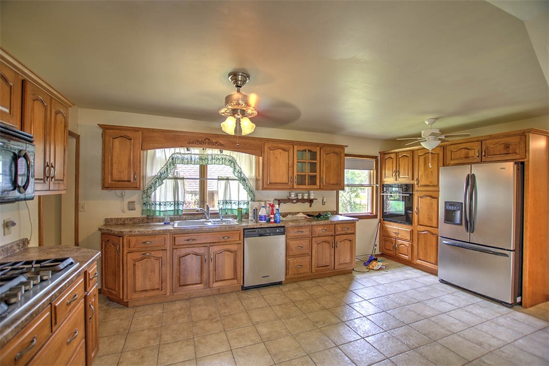 3875 East Maynor Street Decatur, IL 62521 - Photo 16 of 32 a kitchen with stove cabinets and stainless steel appliances