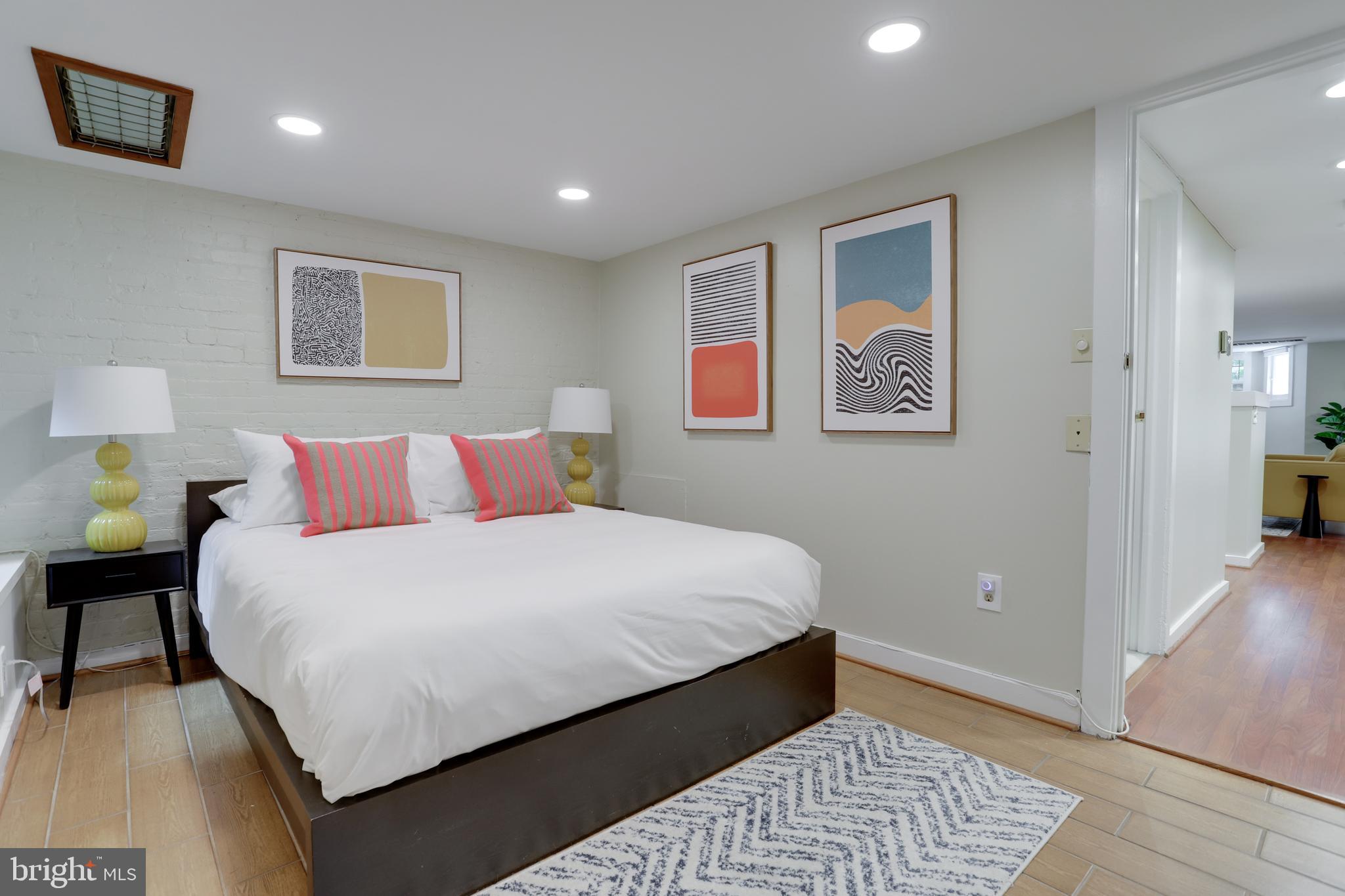 1010 Independence Avenue Southeast, Unit B Washington, DC 20003 - Photo 14 of 17 a bedroom with bed and painting on the wall