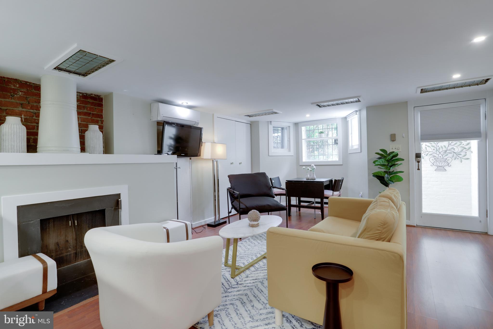 1010 Independence Avenue Southeast, Unit B Washington, DC 20003 - Photo 4 of 17 a living room with furniture a fireplace and a window