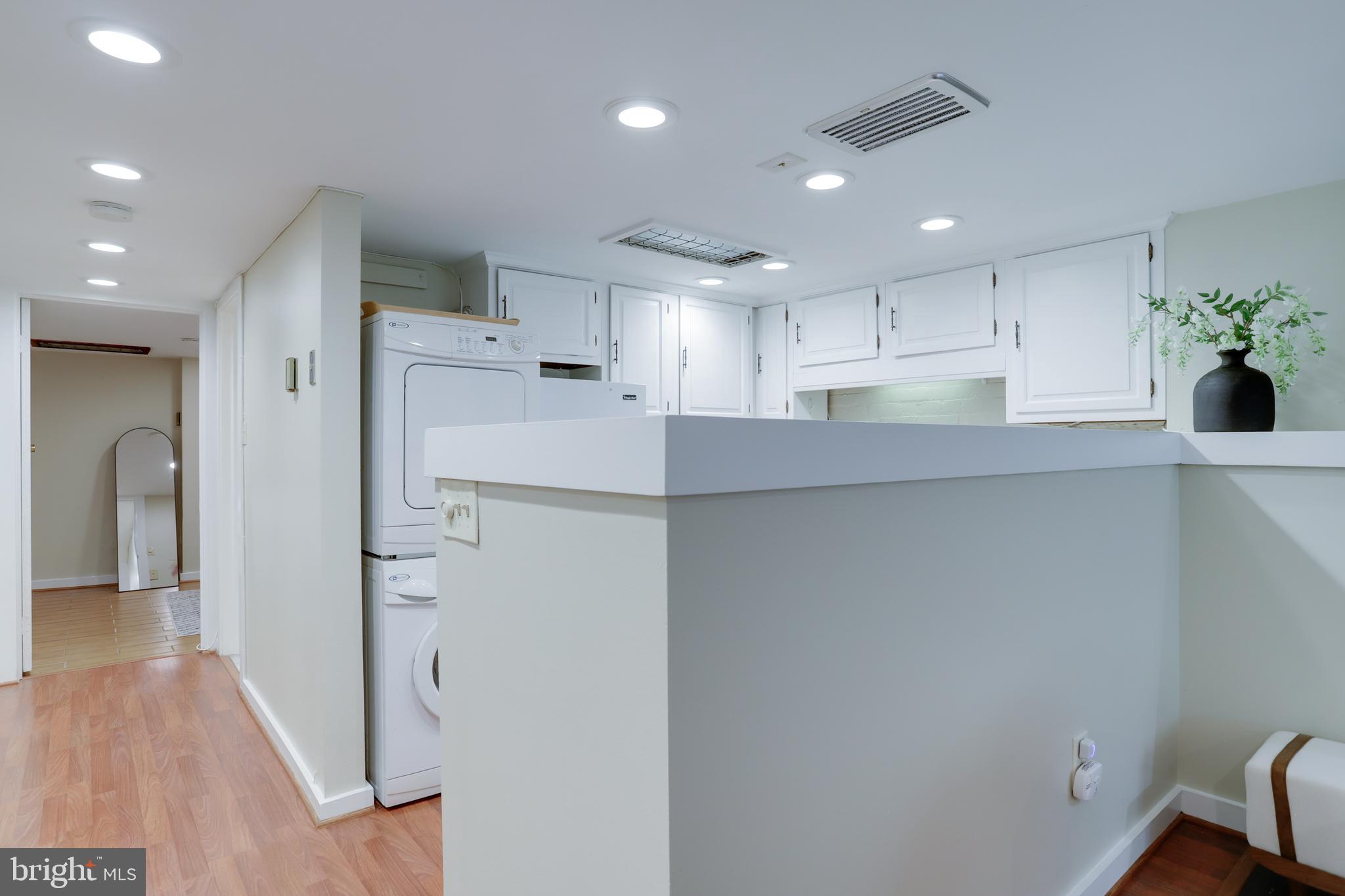 1010 Independence Avenue Southeast, Unit B Washington, DC 20003 - Photo 8 of 17 a kitchen with stainless steel appliances a refrigerator sink and cabinets