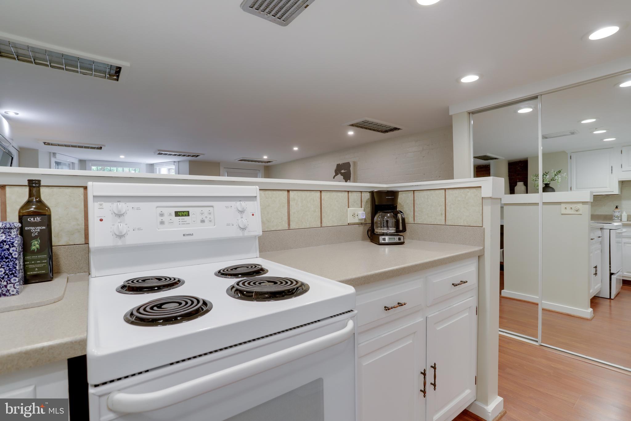 1010 Independence Avenue Southeast, Unit B Washington, DC 20003 - Photo 9 of 17 a kitchen with a stove and white cabinets