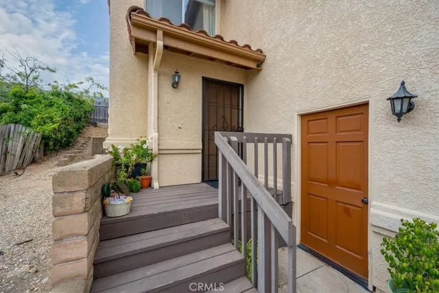 a view of balcony with wooden floor and potted plants