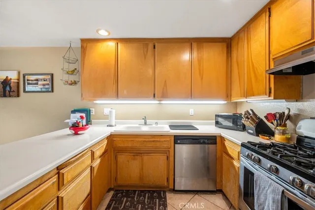 a kitchen with a sink stove top oven and cabinets