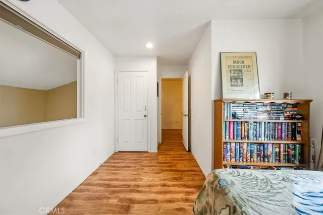 a bedroom with bed and a book shelf