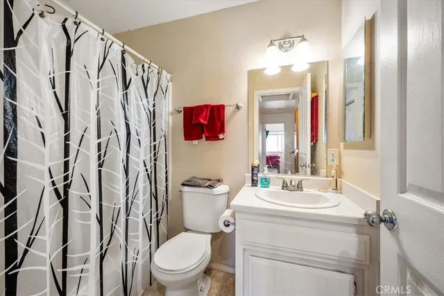 a bathroom with a toilet sink shower and mirror