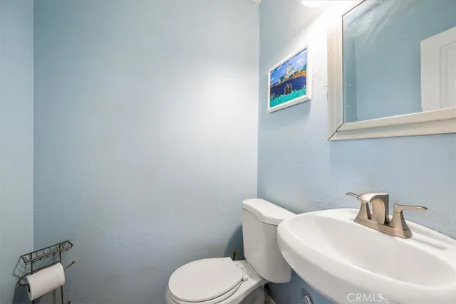 a white toilet sitting next to a bathroom sink