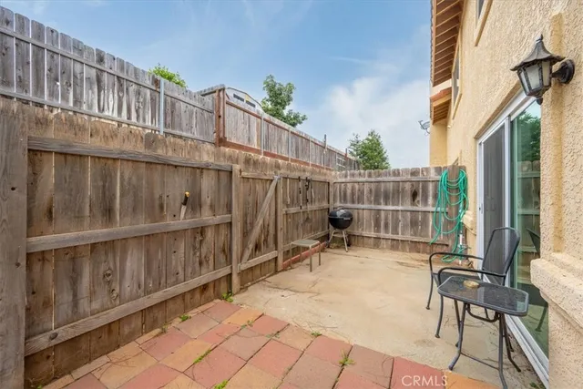 a backyard of a house with table and chairs