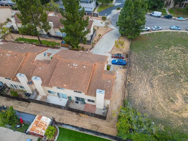 an aerial view of a house with a yard basket ball court and outdoor seating