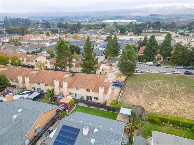an aerial view of a house with a garden and lake view
