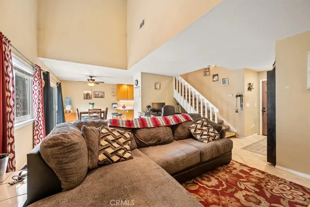 a living room with furniture and stairs