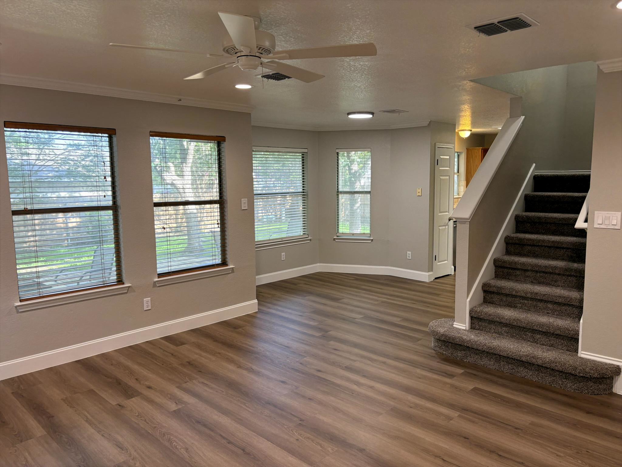 14707 Single Trace Austin, TX 78728 - Photo 9 of 17 A spacious living area with resilient flooring and ample natural light from multiple windows.