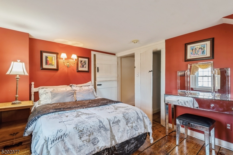 6 Hanover Road Florham Park, NJ 07932 - Photo 22 of 26 a bedroom with a bed and a table in it