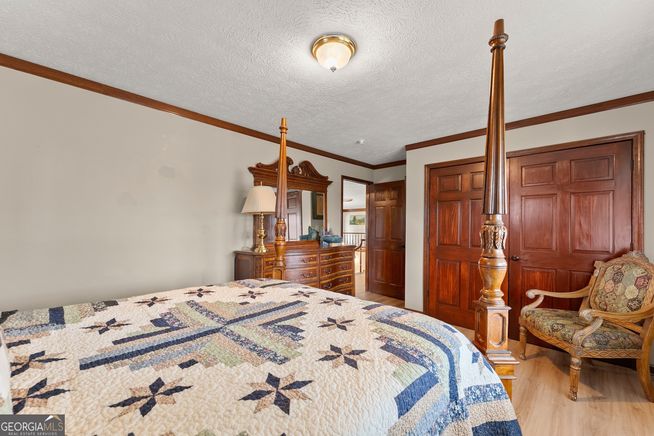 7215 Kelly Bridge Road Dawsonville, GA 30534 - Photo 31 of 81 a bedroom with a bed and a dresser with wooden floor