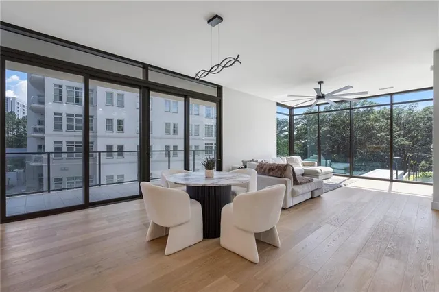 a living room with couches a coffee table and with outer view