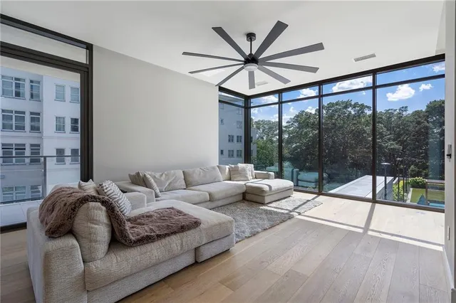 a view of a balcony with floor to ceiling windows wooden floor