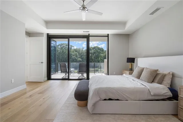 a bedroom with a bed and a large window