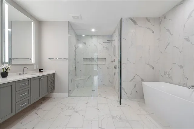 a spacious bathroom with a double vanity sink a mirror and a shower