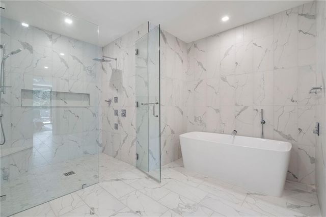 a bathroom with a bathtub and a shower