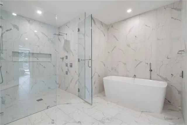 a bathroom with a bathtub and a shower