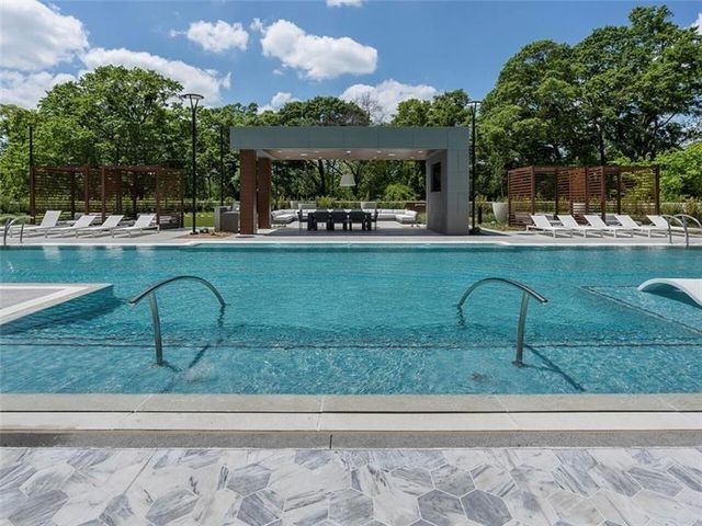 a view of a swimming pool with a yard