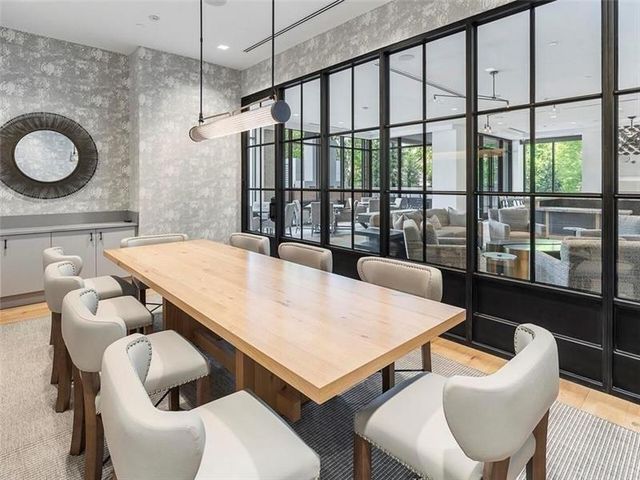 a living room with hardwood floor and large windows