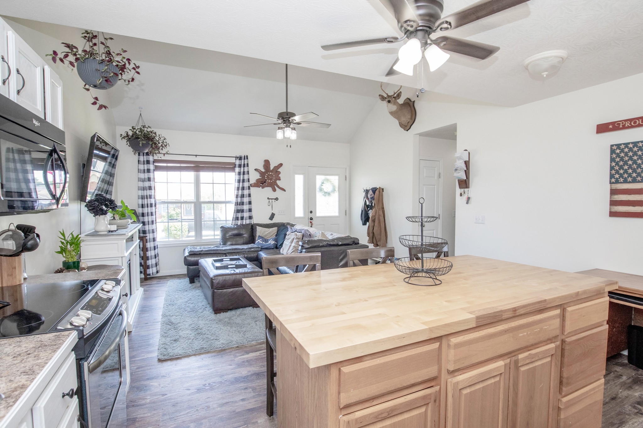 148 Filly Lane Springfield, TN 37172 - Photo 16 of 33 a kitchen with a stove a kitchen island a dining table and chairs with wooden floor