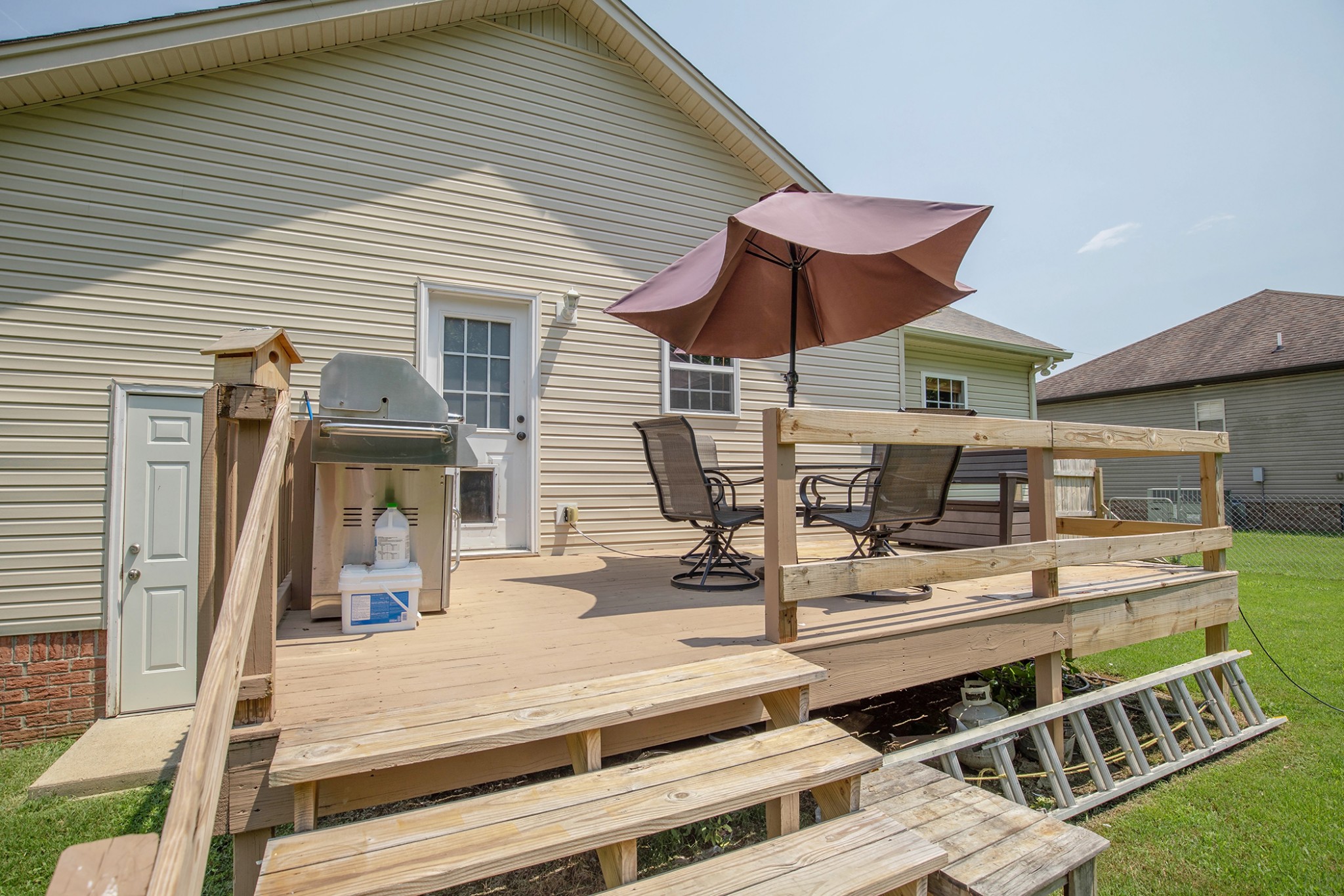 148 Filly Lane Springfield, TN 37172 - Photo 31 of 33 a view of a patio with table and chairs under an umbrella